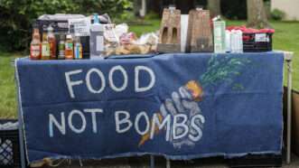 Food Not Bombs table with donated food on it | Stephen Zenner / SOPA Images/Sip/Newscom