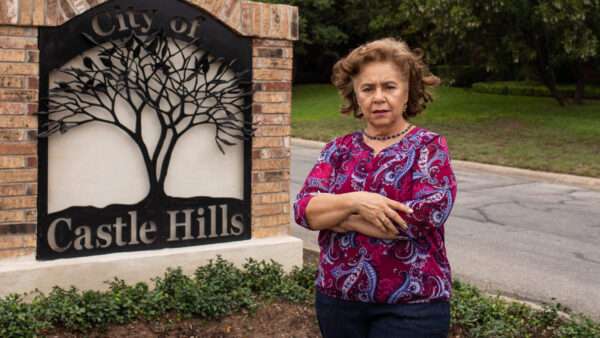 Sylvia Gonzalez outside of the Castle Hills, Texas sign | Institute for Justice